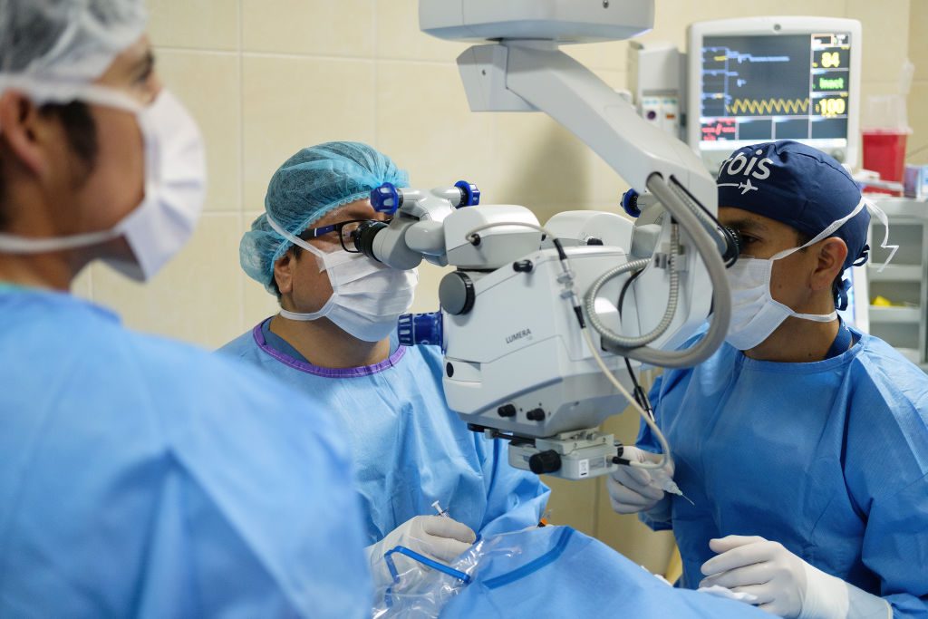 Surgeons work to remove the cataract from a 60-year-old woman at the Regional Institute for Ophthalmology in Trujillo, Peru.