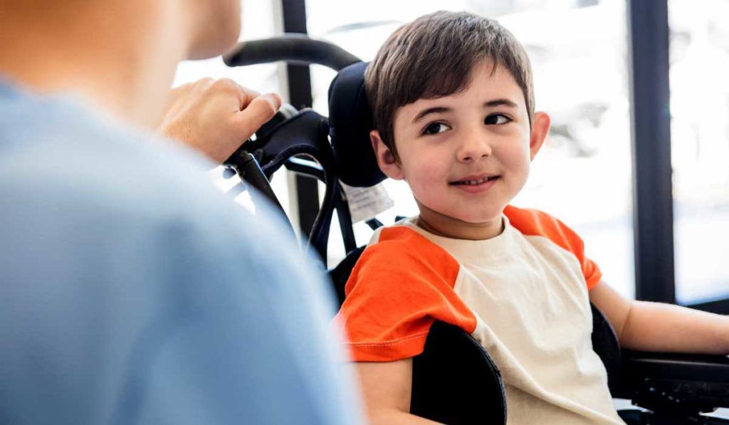 Young boy in a wheelchair with DMD.