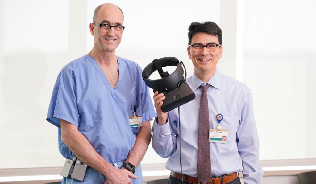Surgeons holding up VR technology to assist in research.