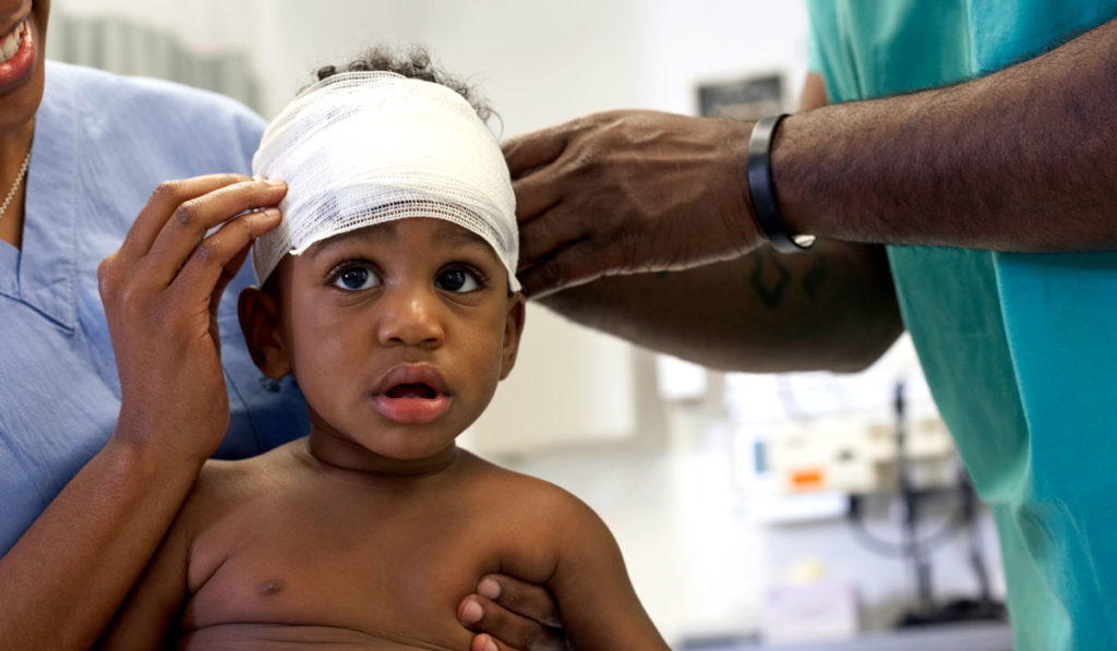 African-American child at a followup appointment after CNS tumor surgery.