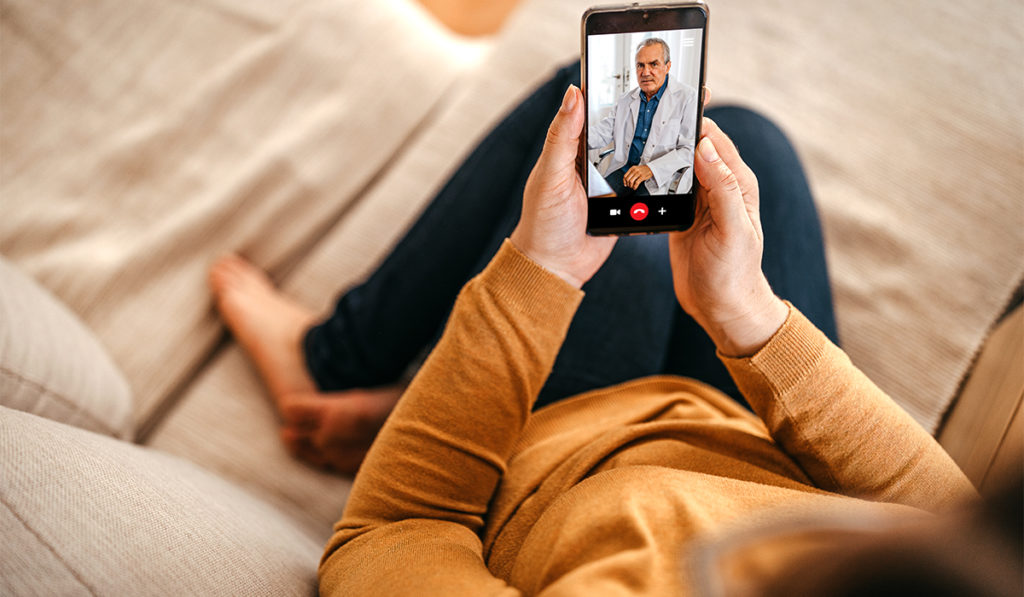 Patient using a telehealth service to video chat doctor over her smartphone.