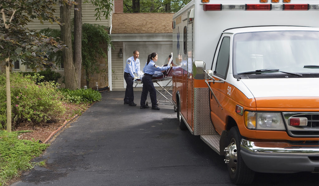 Paramedics putting person into ambulance