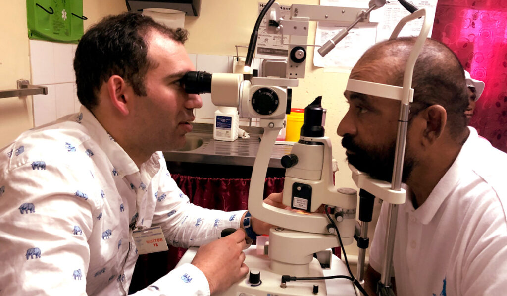 Eye doctor viewing a patient's eyes
