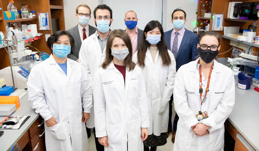 Doctors posing for photo in a lab