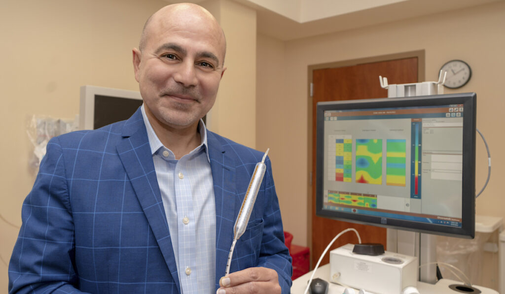 Doctor holding diagnostic tool that was developed about Vanderbilt University Medical Center.