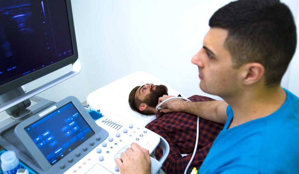 Doctor taking ultrasound of patient's throat.