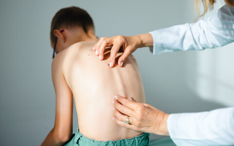 Child having spine checked for scoliosis