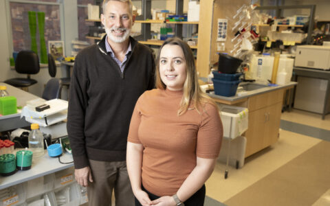 Environmental portrait of doctors Rathmell and Voss in lab