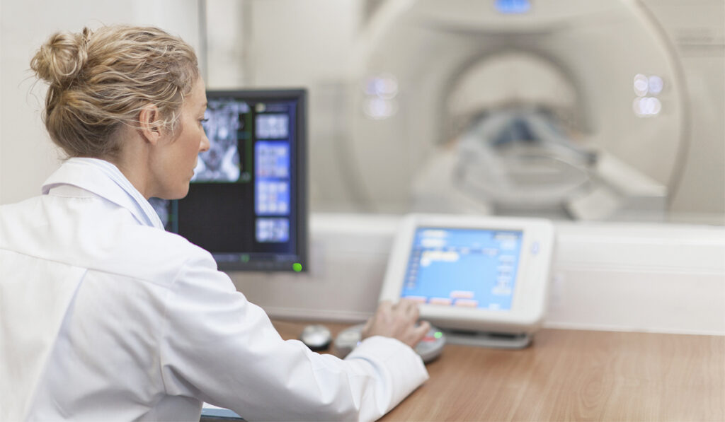 Female physician working MRI machine