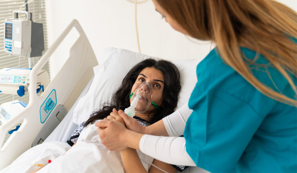Woman in hospital with oxygen mask