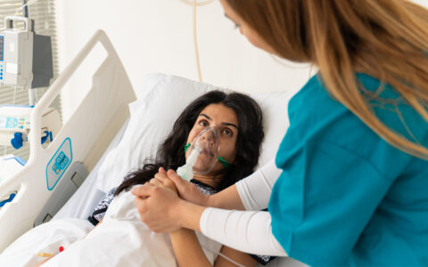 Woman in hospital with oxygen mask
