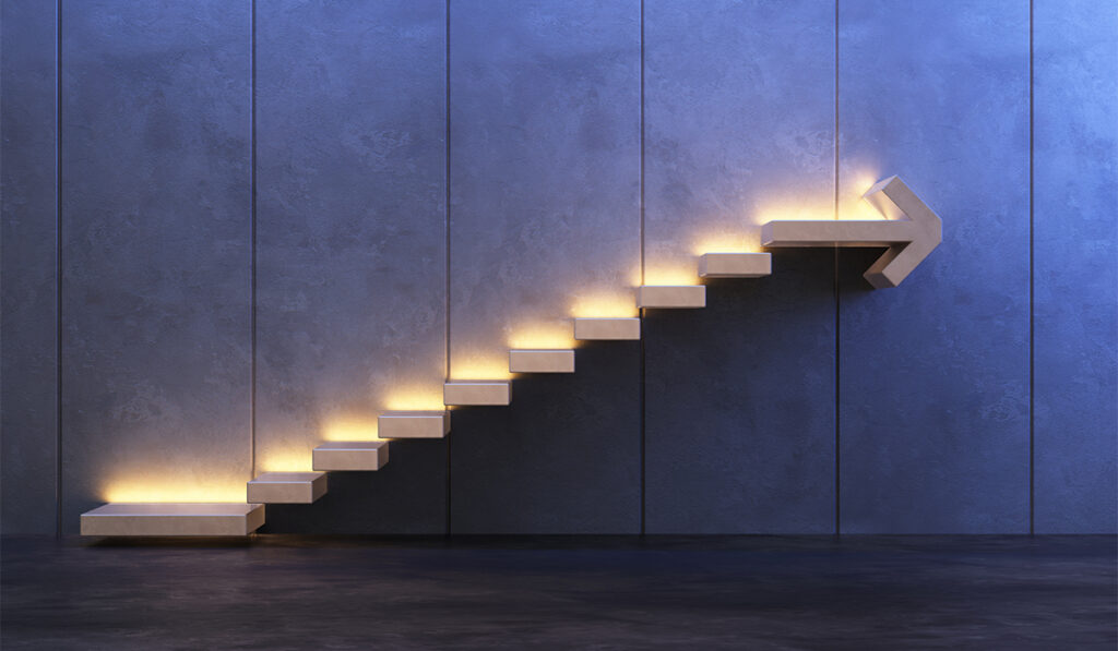 Concept -- lighted stairway with arrow at top