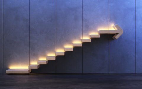 Concept -- lighted stairway with arrow at top