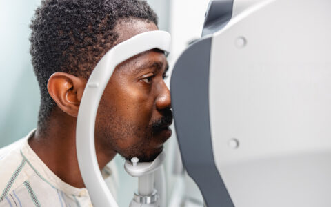 African-American man taking an eye exam at a clinic.