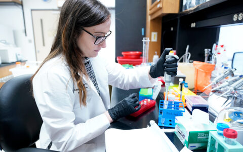 Dr. Andreana Holowatyj doing research in her lab