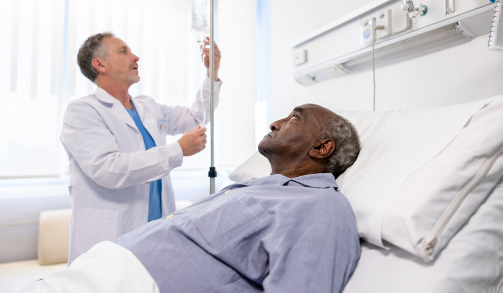Doctor adjusting the IV drip on a hospitalized senior patient