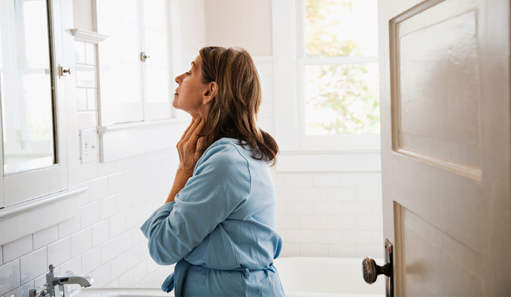 Middle-aged woman looking at herself in the mirror