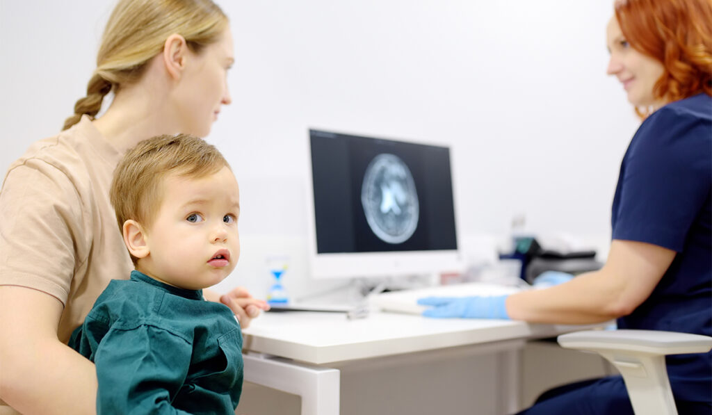 Toddler boy with his mom at neuro appointment