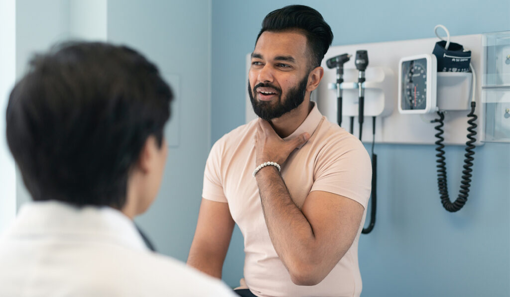 Young man at a checkup to investigate throat issues